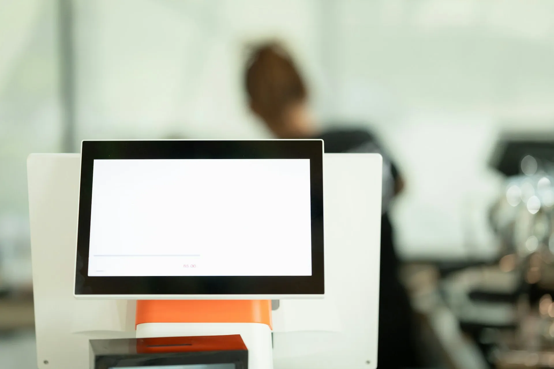 A replacement terminal arrives blank. Every screen, tag, alarm and communication path has to be accounted for before cutover, not after. Blank touchscreen terminal on a white stand with a person blurred in the background