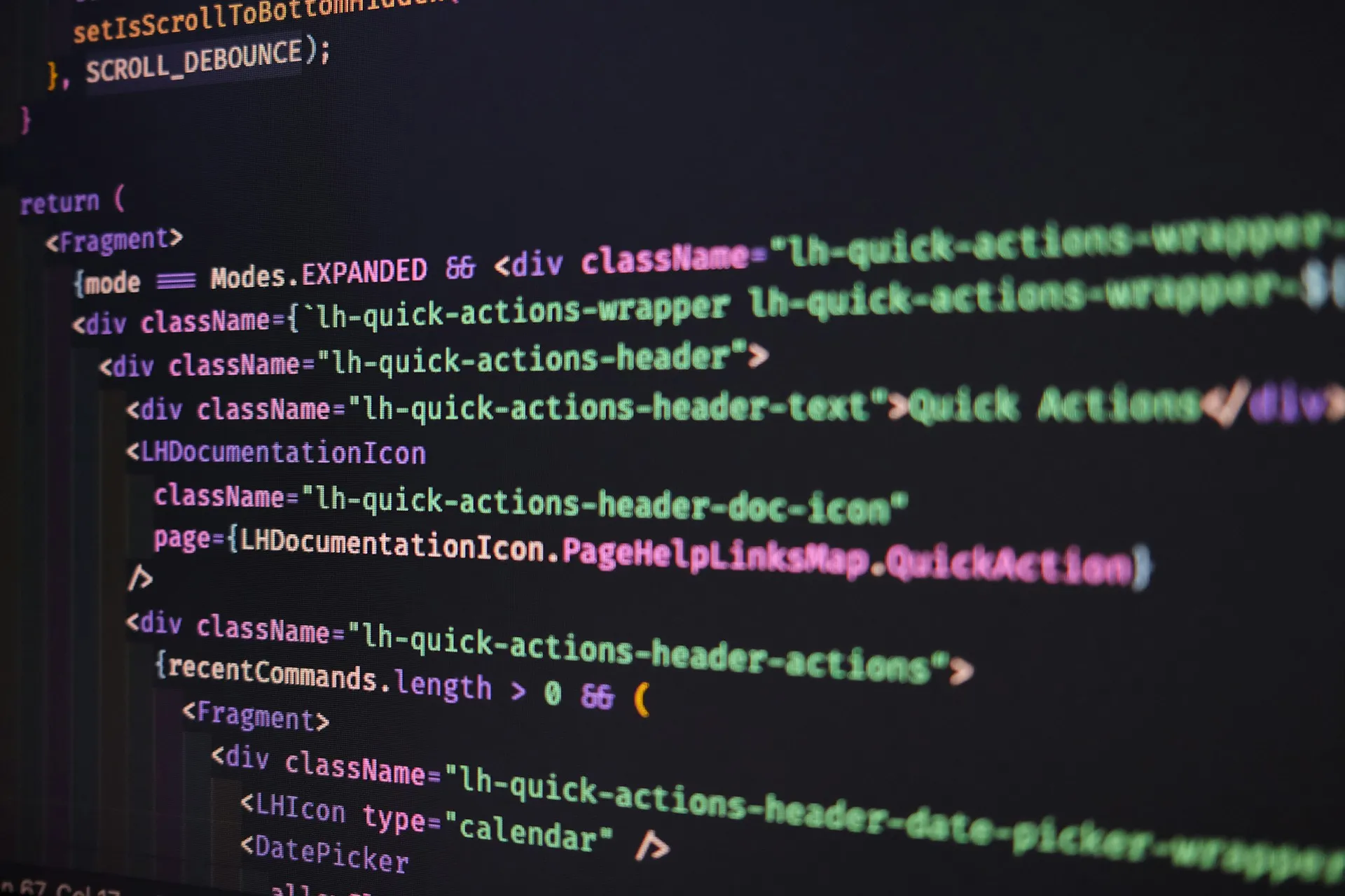 A compare shows exactly which lines changed. Whether the change was right for the process is a question only an engineer who knows the machine can answer. Close-up of a monitor showing nested lines of source code in a dark editor theme
