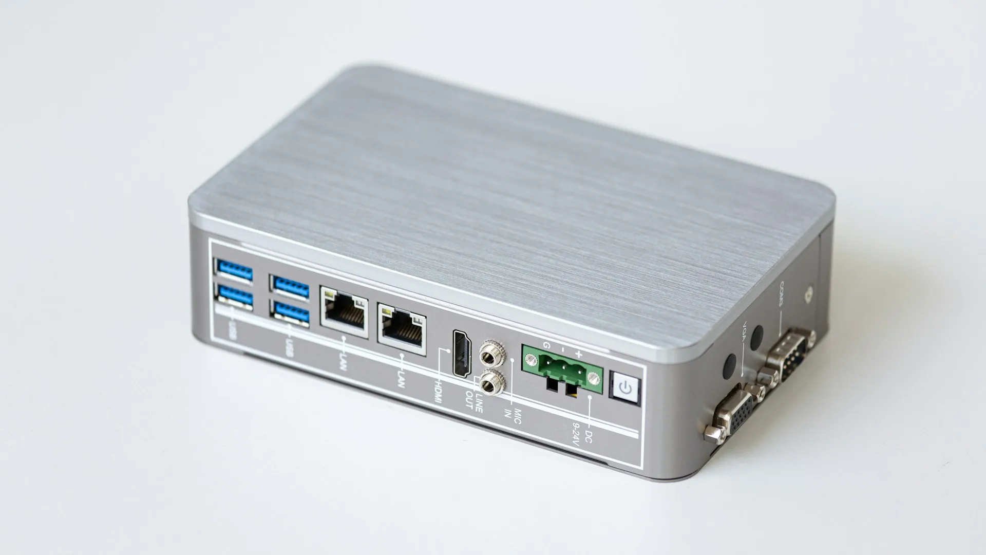 The first buffer is the edge box itself. If it can hold a shift of data on disk, a WAN outage becomes a delay in reporting rather than a gap in the record. Compact fanless silver edge computer showing ethernet, serial, USB ports and a green power terminal