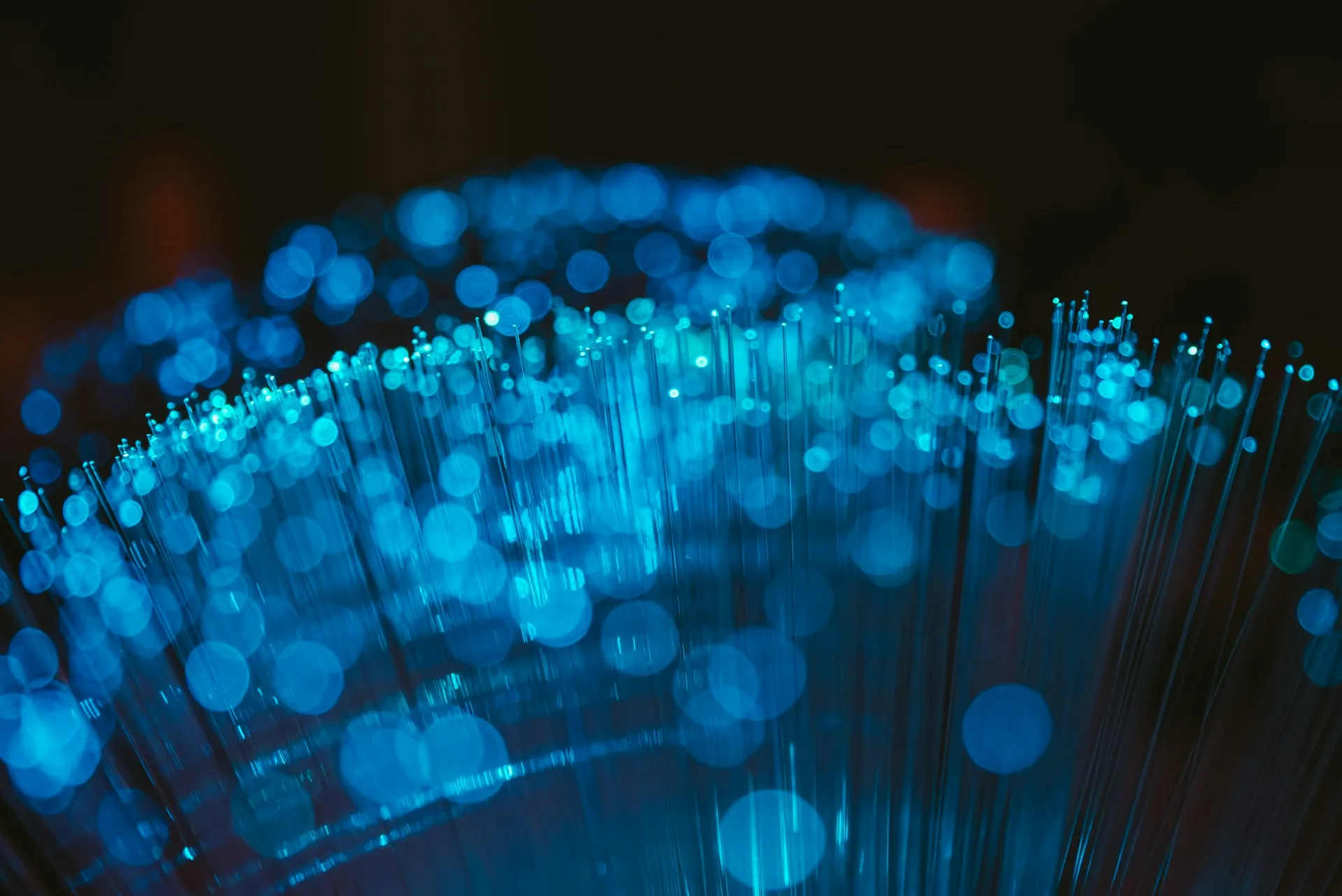 A mesh is only as good as the links under it. Size the buffer at each plant for the longest WAN outage you plan to survive, not the average one. Close-up of a bundle of fibre optic strands glowing blue against a dark background