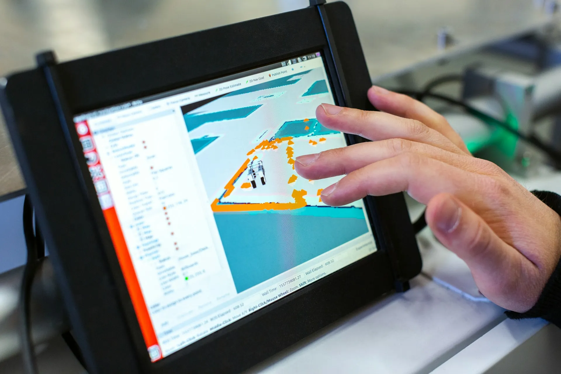 An agent, like a mobile robot, is only as good as its picture of the world. Events keep that picture current without the agent having to keep asking. Hand touching a rugged tablet showing a robot navigation map and configuration panel