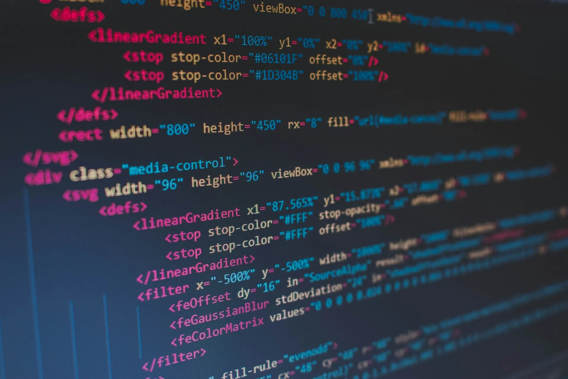 Connecting, subscribing and handling an event takes a few lines in any Solace API; the real decisions are delivery mode, acknowledgement and error handling. Close-up of colourful source code markup on a dark computer screen