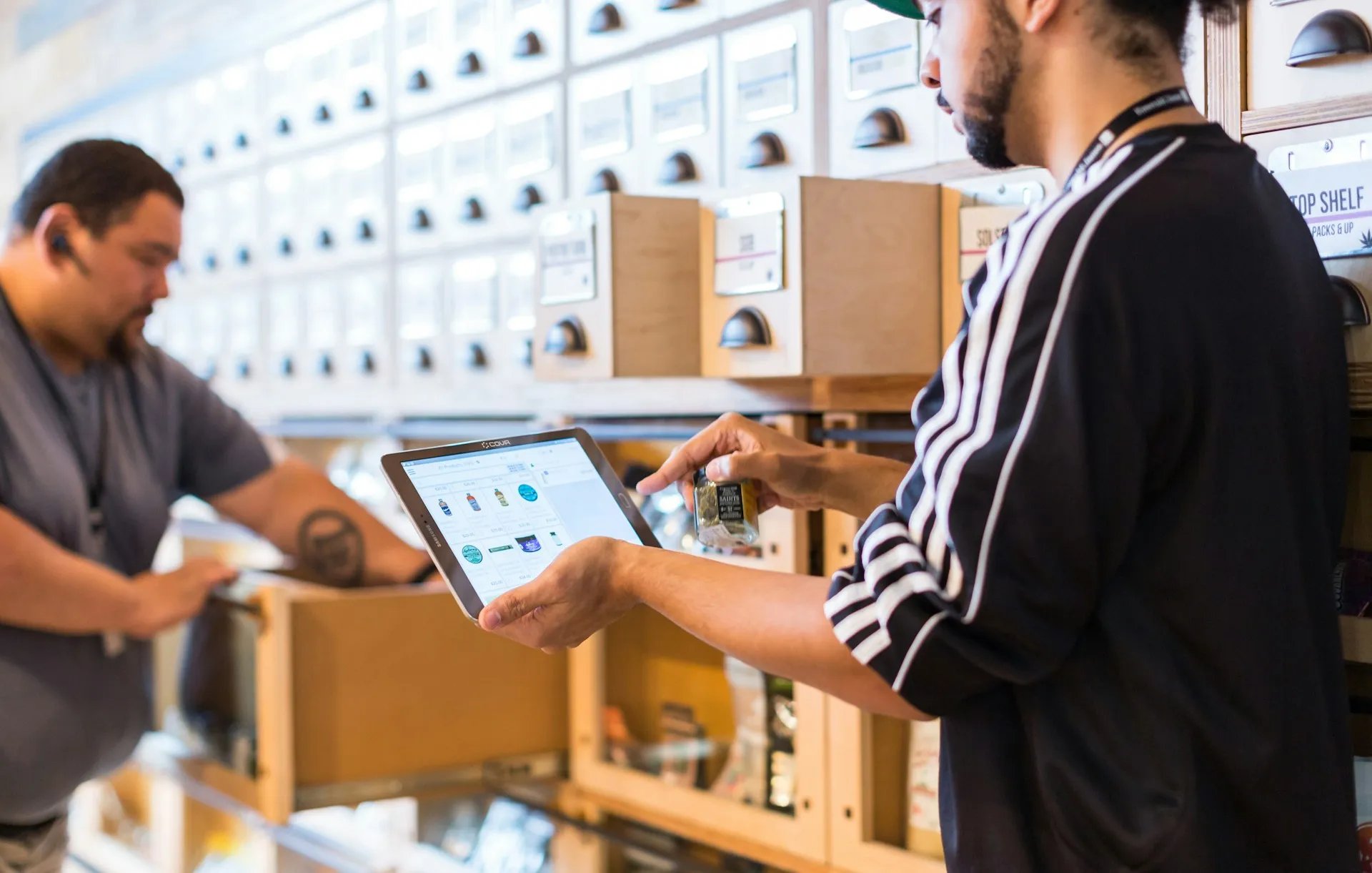 An inventory is only as good as the way it is built: counted by hand, inferred from traffic, or read from the device configuration. Each method misses something different. Two workers checking boxed items against a list on a tablet in front of storage drawers